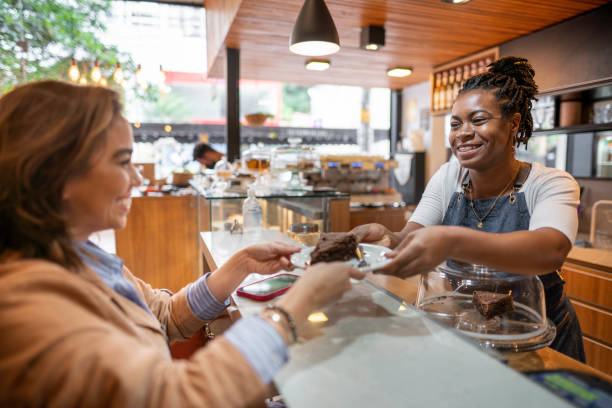 Customer receiving cake at shop